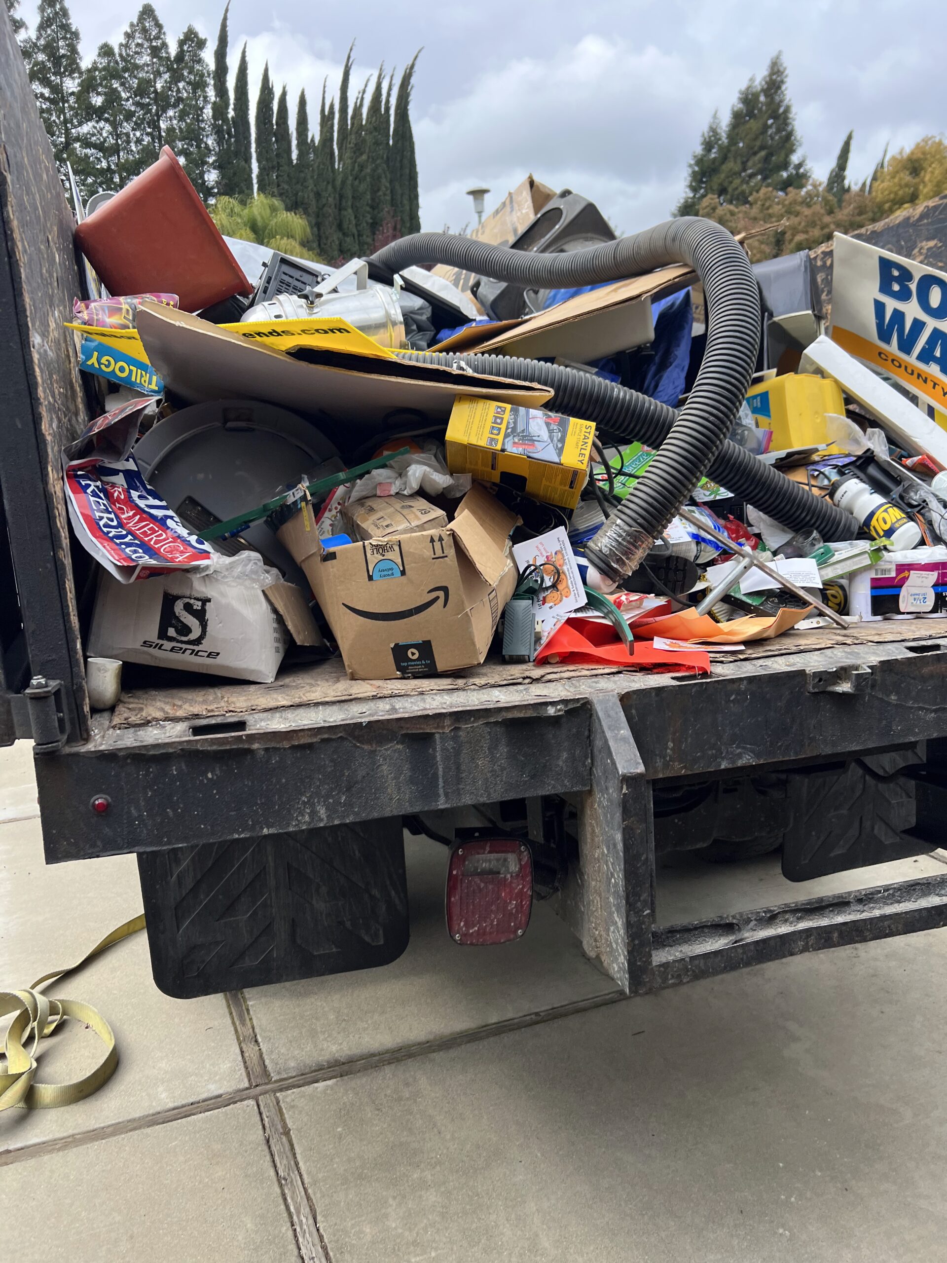 Dump truck filled with yard waste, trash, and debris ready for disposal in Sacramento