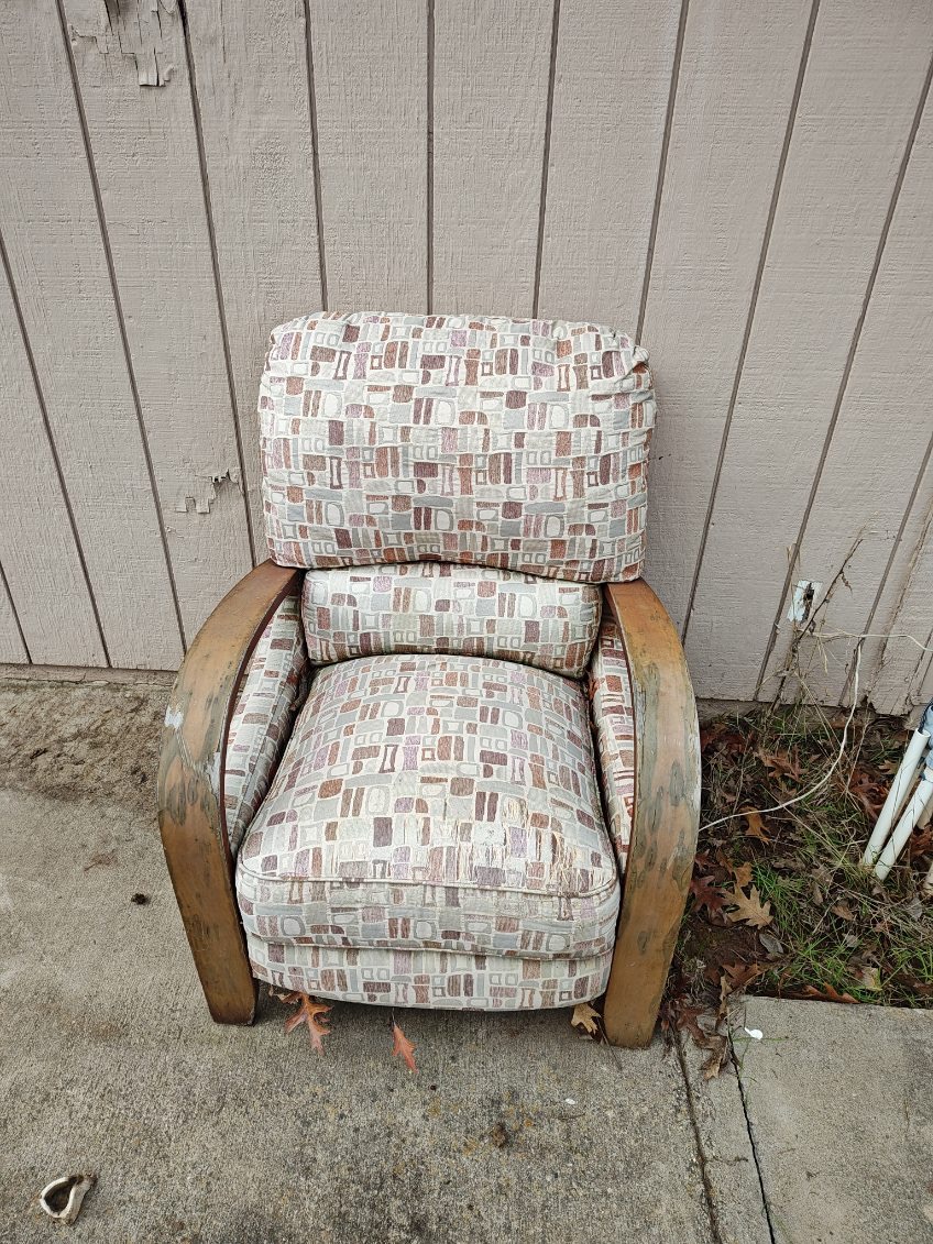 Old chair placed on the curb in Sacramento, waiting for junk removal pickup