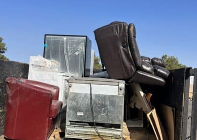 Back of junk removal truck partially filled with old appliances in Sacramento