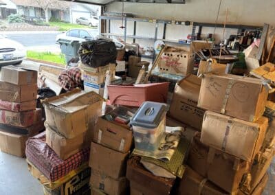 Garage packed with household junk, furniture, and boxes before removal in Sacramento