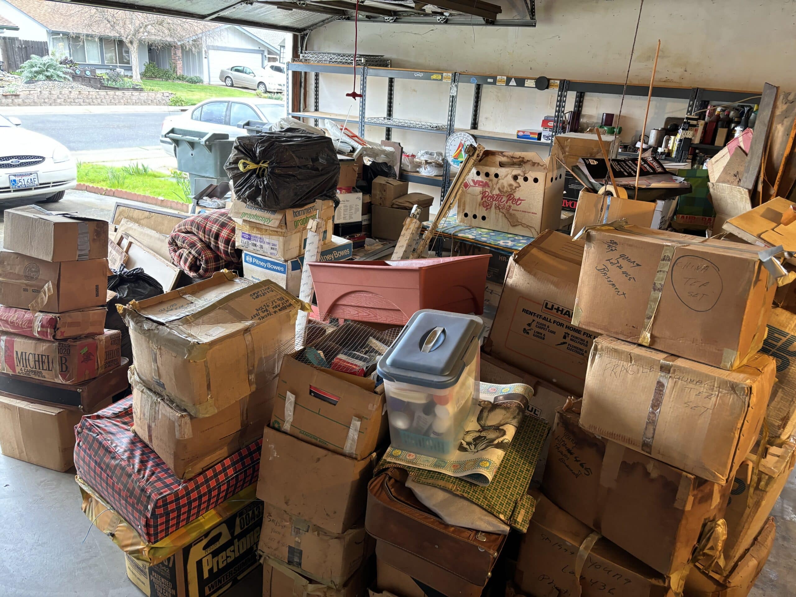 Garage packed with household junk, furniture, and boxes before removal in Sacramento